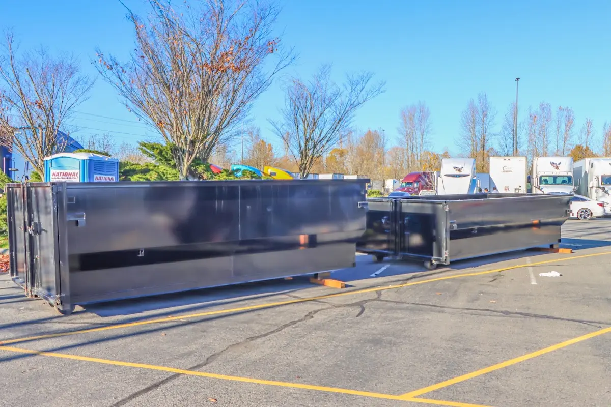 Professional dumpster rental service with roll-off container on residential driveway in Stillwater